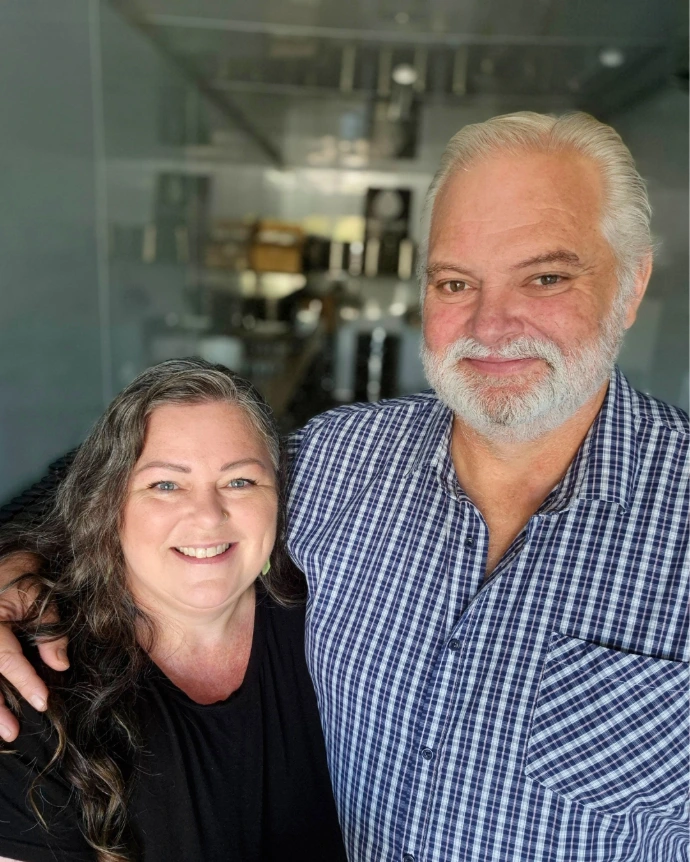 An image of a woman on the left, Debbie, with a tall man to the right, Graeme.